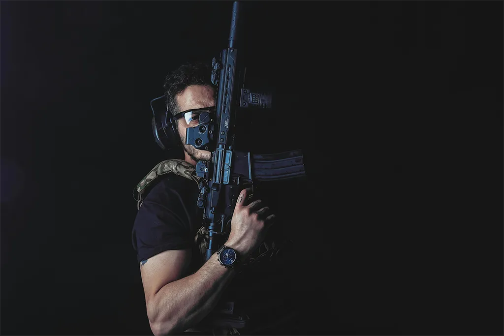 tier 1 tactical Man with a mask, headphones, and goggles holding an assault rifle